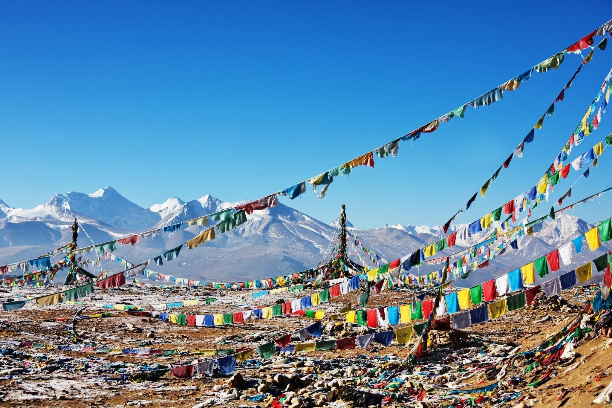 Colorful Buddhist prayer flags against a backdrop of snow-capped Himalayas on the Ama Yangri Trek route, Nepal